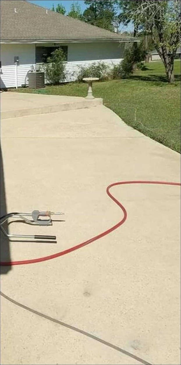 The same concrete driveway cleaned back to a light even finish