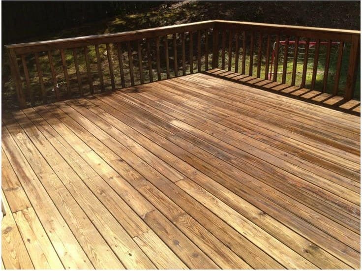 The same deck cleaned, the grain and warm color back in the wood
