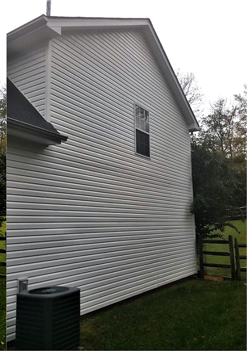 The same siding clean and uniformly white after a soft wash